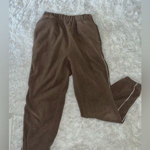 Brown sweat pants with white line down the side